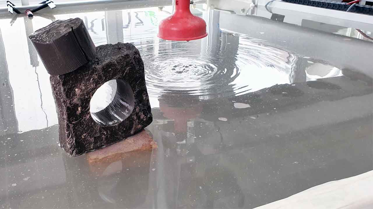 Water Jet cutting a natural stone with 60mm thickness Water Jet cutting a natural stone with 60mm thickness